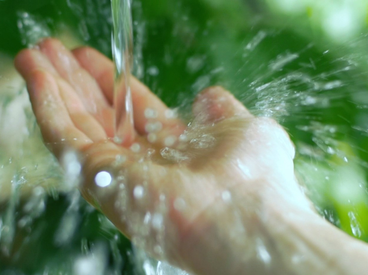 Hand under rippling water